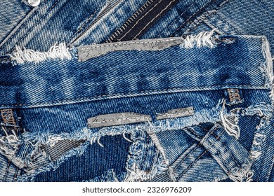 Ripped denim jeans fabric. Destroyed torn denim blue jeans patches background. Recycle old jeans denim pieces concept. Many fragments of jeans cloth.