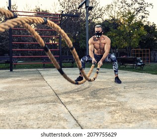 Ripped Guy Wearing A Fitness Mask Doing Cardio With Battle Ropes Outside, Battle Rope Concept