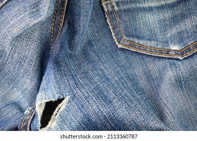 Ripped jeans on the butt. Worn hole in jeans.