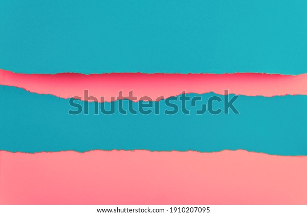 Ripped paper edge with copy space, blue\
and pink color background. Flat lay. Copy\
space.
