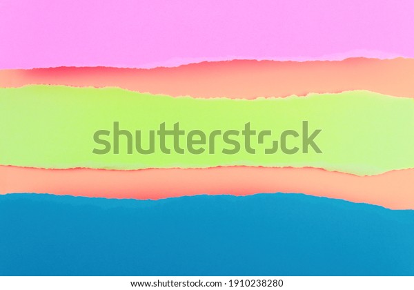 Ripped paper edge with copy space, multicolor\
background. Flat lay. Copy\
space.