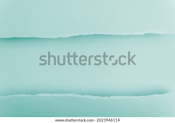 Ripped paper edge with copy space, blue\
background. Flat lay. Copy\
space.