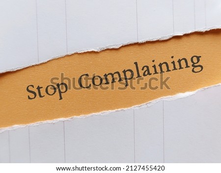 Ripped paper with text Stop Complaining - concept of changing habit of focus negativity, minimize complaining and maximize optimism