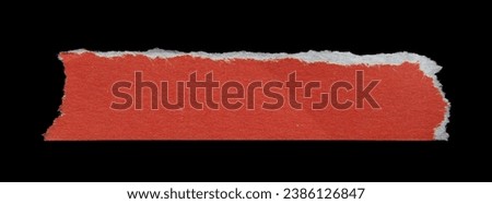 Ripped red paper piece isolated on a black background. Recycled torn paper with copy space.