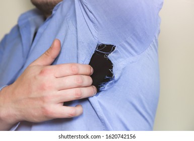 Ripped Shirt. Man In Clothes Which Need Repairing And Sewing.