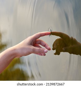 The Ripple Effect. Cropped Shot Of A Finger Touching Water To Form Ripples.