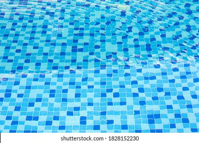 Ripple Water In Swimming Pool With Blue Tile Floor Background