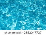 Ripple Water in swimming pool with sun reflection. Wavy water background.