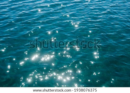 Rippled aquamarine sea water surface glistening in sunlight