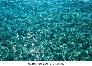 Rippled gleaming aquamarine sea water surface with shiny sparkles
