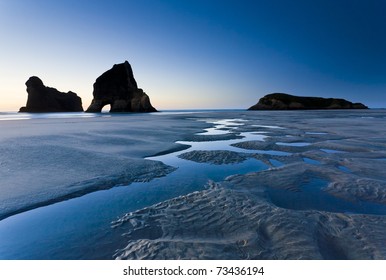 Rippled Sand and rock formations at Wharariki Beach, Nelson, North Island, New Zealand - Powered by Shutterstock