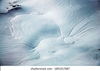 Rippled Snowy Hillside In Mountains.