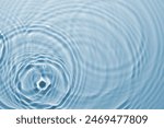 Rippled surface of clear water on light blue background, top view