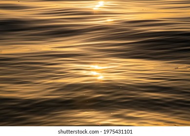 Rippled Water Surface At The Sea During Golden Hour Sunset Close Up