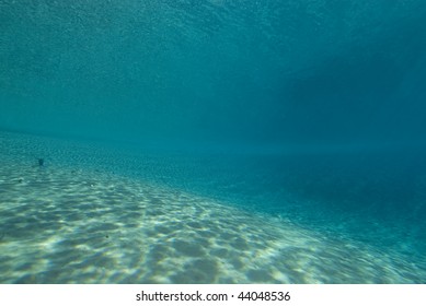 Ripples Sunlight On The Floor Of A Shallow Sandy Bay Reflected By A Calm Ocean Surface. Marsa Bareka, Ras Mohammed National Park, Red Sea, Egypt. MORE INFO: Wide Angle Scenic Shot In Clear Blue Water.