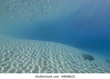 Ripples Sunlight On The Floor Of A Shallow Sandy Bay Reflected By A Calm Ocean Surface. Marsa Bareka, Ras Mohammed National Park, Red Sea, Egypt. MORE INFO: Wide Angle Scenic Shot In Clear Blue Water.