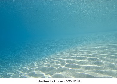 Ripples Sunlight On The Floor Of A Shallow Sandy Bay Reflected By A Calm Ocean Surface. Marsa Bareka, Ras Mohammed National Park, Red Sea, Egypt. MORE INFO: Wide Angle Scenic Shot In Clear Blue Water.