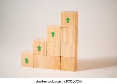 Rise Up Arrow On Wood Block Stacking. Business Concept. Copy Space