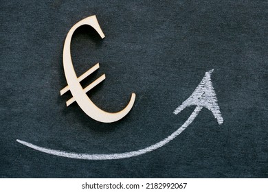 Rise In The Euro Exchange Rate.growth Of The Exchange Rate. Euro Sign And Up Arrow On Black Chalk Board Background.Economic Stability 