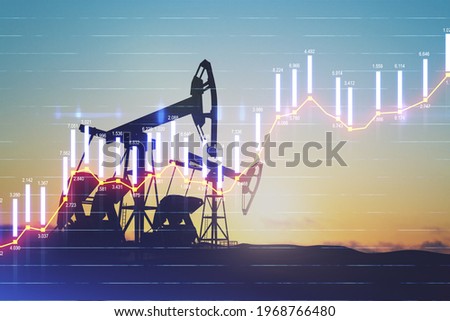 Rise in gasoline prices concept with double exposure of digital screen with growing financial chart candlestick and oil pumps on a field