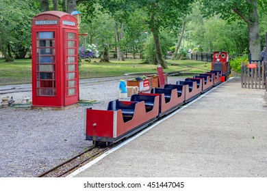 Riseley/UK. 10th July 2016. The Narrow Gauge Railway At Wellington Country Park In Berkshire Beneath The Backdrop Of Trees And Gardens.