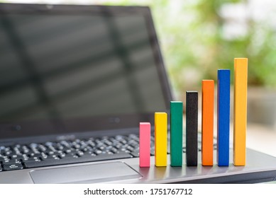 Rising bar graph on a laptop computer, depicting increasing in internet user, e-commerce, online shopping / data traffic growth over cyber or virtual network after the emerging of video live streaming