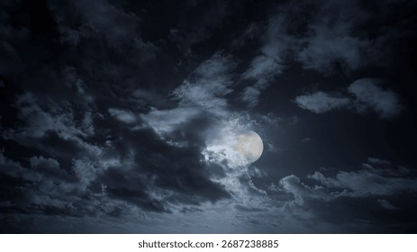 Rising full moon in a dramatic cloudy full moon night