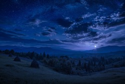 Rising Of The Full Moon In A Mountain Valley With Stars In A Cloudy Night Sky. Dramatic And Picturesque Scene. Carpathians, Ukraine. Beautiful World.