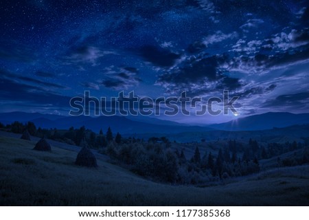 Rising of the full moon in a mountain valley with stars in a cloudy night sky. Dramatic and picturesque scene. Carpathians, Ukraine. Beautiful world. Foto stock © 