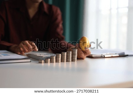 Rising stack of coins on the table and golden eggs on businessman ’s hand metaphor for financial planning and investment return.