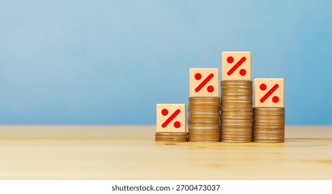 Rising stacked coins with Percentage sign on wooden block. Sales discount, interest rate decline, investment reduce concept - Powered by Shutterstock - Get 15% off with code: PIKWIZARD15