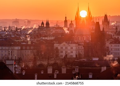 The rising sun in between towers of the Church of Our Lady before Týn in Prague.