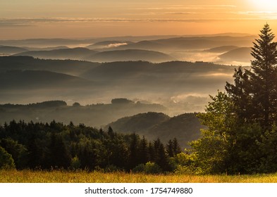 Rising sun rising in the mist over the mountain valleys - Shutterstock ID 1754749880