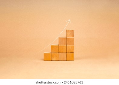 Rising up thin arrow on wooden cube blocks, bar graph chart steps on brown recycle paper background, profit, benefit, income, business growth process, economic improvement concepts, minimal style. - Powered by Shutterstock