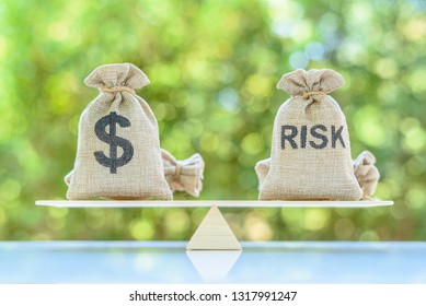 Risk assessment / risk analysis and management concept : Dollar and risk bags on basic balance scale, depict evaluation of financial risk that investor involved in stock, futures and derivative market - Shutterstock ID 1317991247