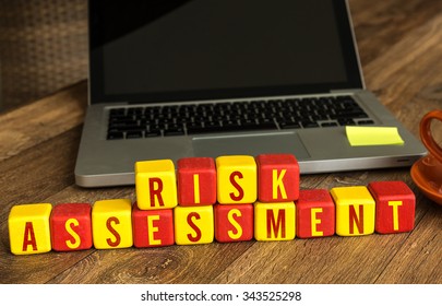 Risk Assessment Written On A Wooden Cube In A Office Desk