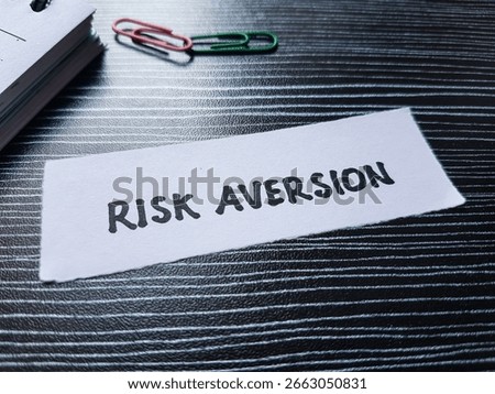 Risk aversion writting on table background.