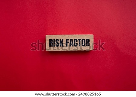 Risk factor message written on wooden block with redbackground. Conceptual risk factor symbol. Copy space.