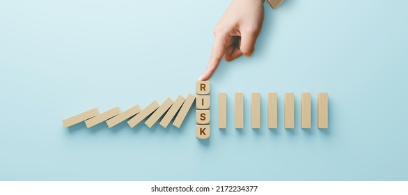 Risk Management Concept. Top View Of Hand Stop Wooden Block Domino Effect For Business