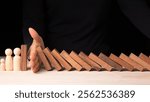 Risk Management and Decision Making Hand Stopping Falling Dominos in a Business Crisis Concept Studio Environment Close-up View