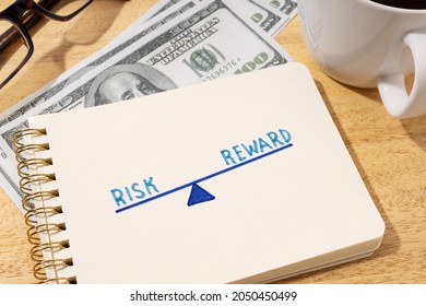 Risk Reward Concept. Drawing On Notepad On Desk