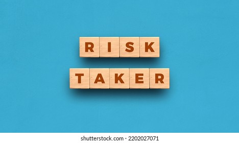 Risk Taker - word written on wooden blocks with blue background