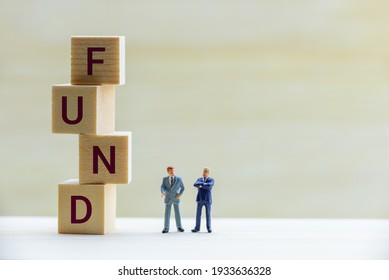 Risky asset investment with risk of portfolio collapsing, financial concept : Businessmen or fund manager talk or discuss near square cubes, depict exchanging ideas on bond market chance and situation - Shutterstock ID 1933636328