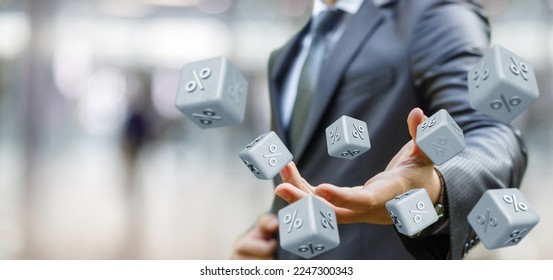 Risky investment concept.Businessman throws dice with percent inscription on blurred background.