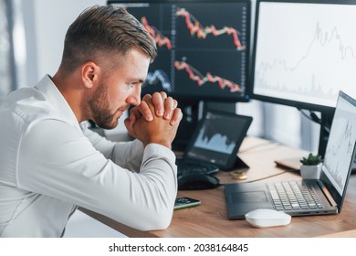 Risky Job. Young Businessman In Formal Clothes Is In Office With Multiple Screens.