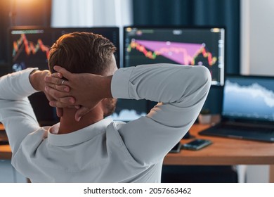 Risky Job. Young Businessman In Formal Clothes Is In Office With Multiple Screens.