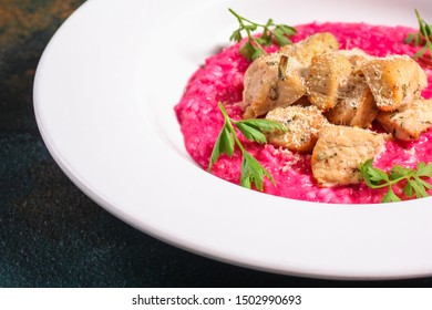 risotto
chicken meat (red rice with beetroot flavor) menu concept. food background. copy space. Top view