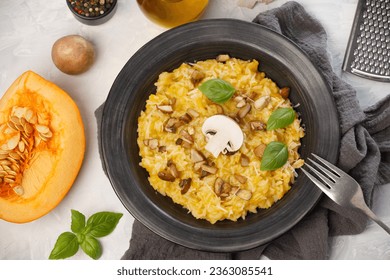 Risotto with pumpkin and mushrooms close-up on a white background, close-up, top view