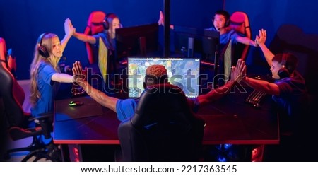 Ritual help of uniting and preparing professional cyber team for playing in tournament online video game. Soft focus, neon color back view.