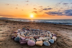 Ritual Stones For Spiritual Ceremony Are Are Arranged In A Circle During Sunset On The Beach